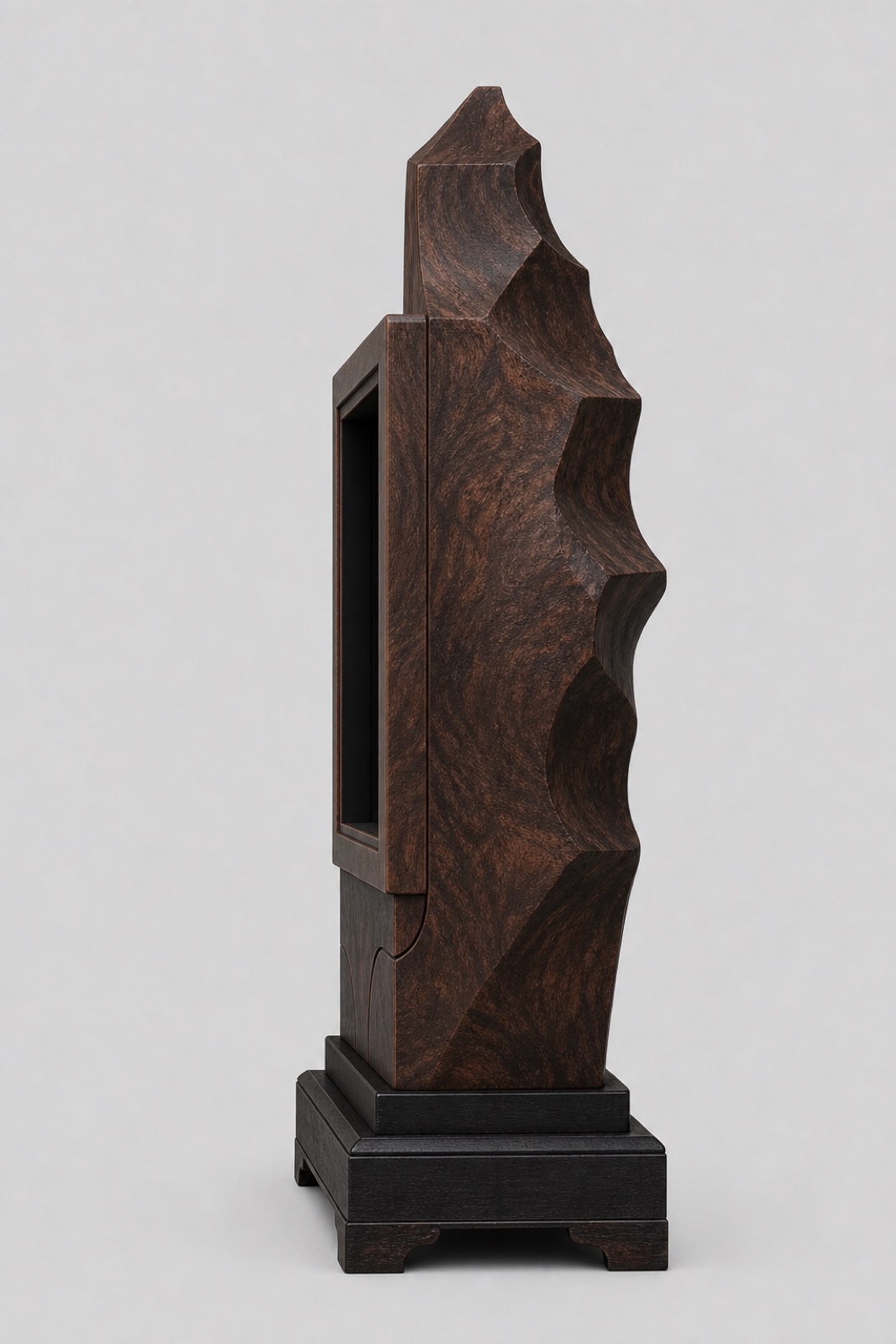 Right side view of the walnut burl cabinet showing the opposite carved edge and black plinth.
